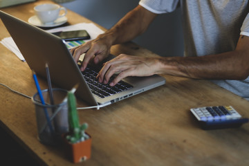 Asian man working from hone online because of covid-19. Work at home and social distancing concept. Selective focus.