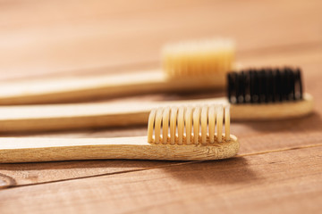 Bamboo toothbrushes on the wooden surface