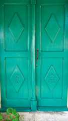 Old wooden green door of a mediterranean house.