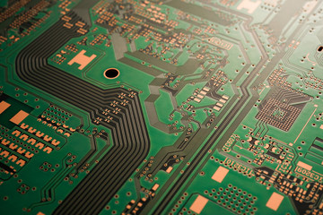 A close-up of black Green coloured Printed circuit board (PCB) with no component mounted (copper...