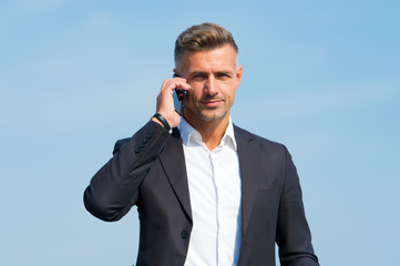 Hello, answer the phone. Businessman call on mobile phone. Handsome man with cell phone outdoors. Business communication. Phone for professional use. 3G. 4G. Mobile lifestyle. New technology