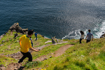 Group of young people enjoying the breathtaking view of the sea while descending