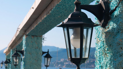 Old lanterns as street lighting during a sunny day - Rose Village, Kotor Bay, Montenegro, Europe.