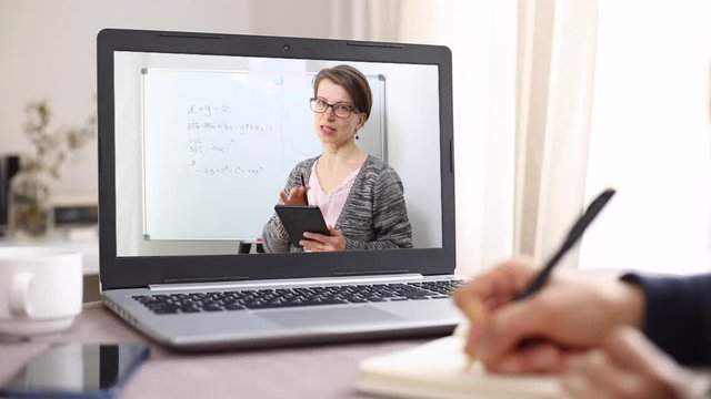 Online learning at home. The teacher explains the lesson to the child on the laptop screen.  Remote education.