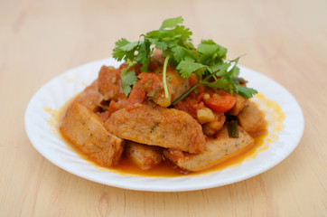 fishcake slices fried with stew sauce in plate