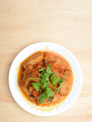 Plate of stew tomato sauce fishcakes meal