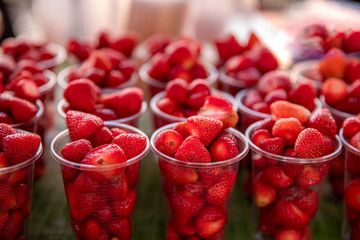 Fresh strawberry fruit in plastic glass.