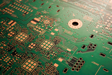 A close-up of black Green coloured Printed circuit board (PCB) with no component mounted (copper exposed)