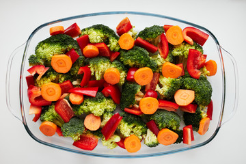 A mix of broccoli, bell pepper (paprika) and round slices of carrot. Bright and colorful close up picture of diet recipe.