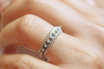 Hand wearing elegant silver ring in oriental shape