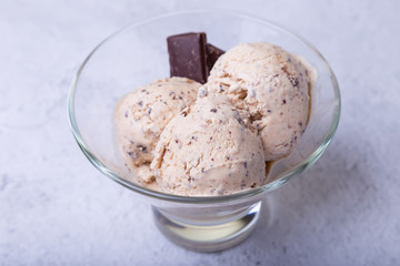 Homemade ice cream with chocolate chips in a bowl. Three balls of ice cream. Close-up.