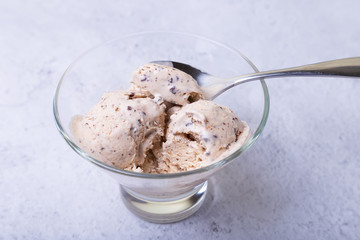 Homemade ice cream with chocolate chips in a bowl. Three balls of ice cream. Close-up.