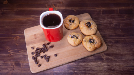 red coffee mug with cookies and coffee beans