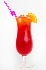 red fruit punch in a tall glass decorated with sliced orange and straw white background