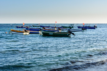 Fishing boats on the South China Sea coast, Da Dong Hai Bay at sunset.