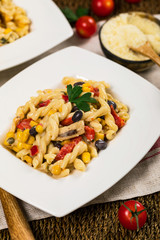 Cheesy Grilled Chicken Alfredo Pasta Florentine with Black Beans and Corn. Selective focus.