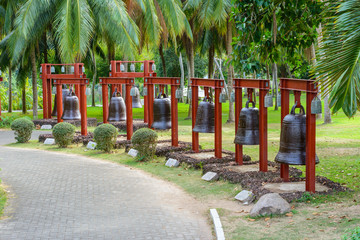 The alley Bells with chinese hieroglyphs on the territory of Buddhist center Nanshan.