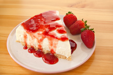 delicious cheesecake with strawberries on  plate