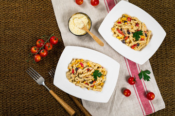 Cheesy Grilled Chicken Alfredo Pasta Florentine with Black Beans and Corn. Selective focus.
