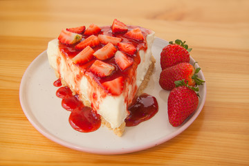 delicious cheesecake with strawberries on  plate