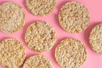 Puffed rice cakes on pink background. Flat lay, top view. Rice waffle on colored background.
