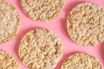 Puffed rice cakes on pink background. Flat lay, top view. Rice waffle on colored background.