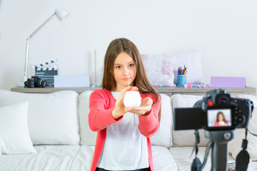 Teen blogger presenting beauty products and broadcasting live videos on social networks. Focus on teen girls influencer bloggers. Beauty bloggers and vlog concept.
