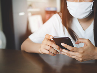 Asian woman video calling with smartphone at home, meeting online by app, social distancing, work from home, Stop the spread of the coronavirus or covid-19 concept.
