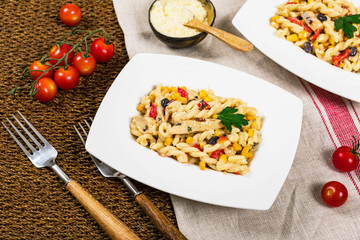 Cheesy Grilled Chicken Alfredo Pasta Florentine with Black Beans and Corn. Selective focus.