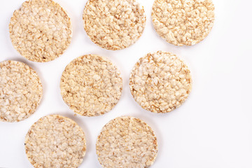 Puffed rice cakes on white background. Flat lay, top view. Rice waffle. copy space