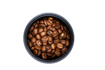 Grains of black coffee in a container on a white background