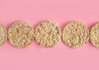 Puffed rice cakes on pink background. Flat lay, top view. Rice waffle on colored background.