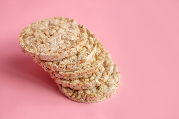 Puffed rice cakes on pink background. Flat lay, top view. Rice waffle on colored background.