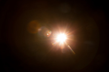 Abstract Natural Sun flare on the black background.