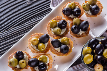 delicious snack tartlets on rustic wooden background