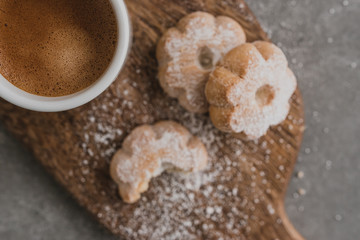 Italian espresso coffee and biscuits on wooden cut board. Selective focus