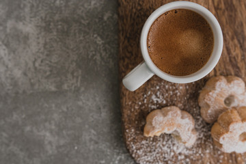 Italian espresso coffee and biscuits on wooden cut board. Selective focus