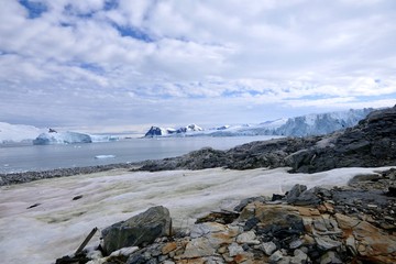 Iceberg and glacier with stony Island in antarctic sea, Antarctica, Stonington Island