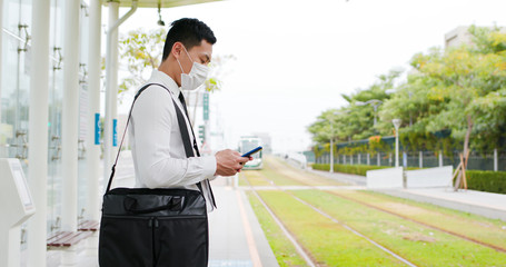 man use smartphone with mask