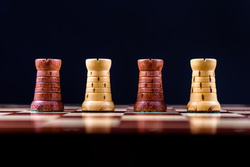four chess rooks on a black background