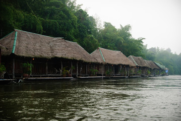 Fototapeta na wymiar Floating wooden hotel on the river Kwai misty morning
