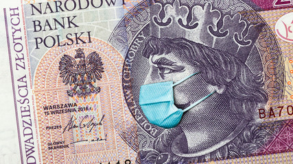 Coronavirus in Poland. Quarantine and global recession. 20 Polish zloty banknote with face mask against infection. Global economy hit by covid19.National Bank of Poland prints money to save bugdet
