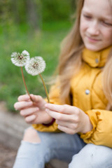 girl holding dandelion