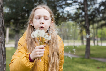 girl holding dandelion