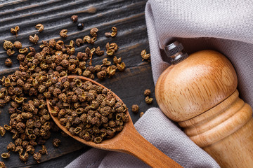 Sichuan pepper on a dark wooden rustic background