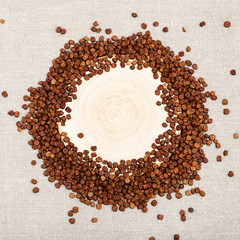 Small grains of legumes bean seeds in form round frame. Grey peas and wooden desk. Natural food background. Healthy eating. Gluten-free product.