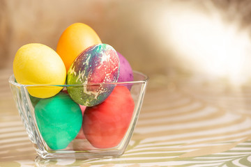 A glass plate with eggs on the table, the background is blurred