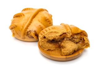 walnut buns with couple of bites on a white background