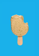 half eaten matcha popsicle on a blue background
