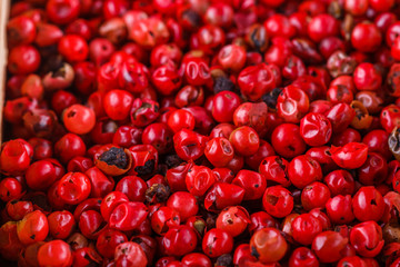fragrant pink peppercorns on white acrylic background